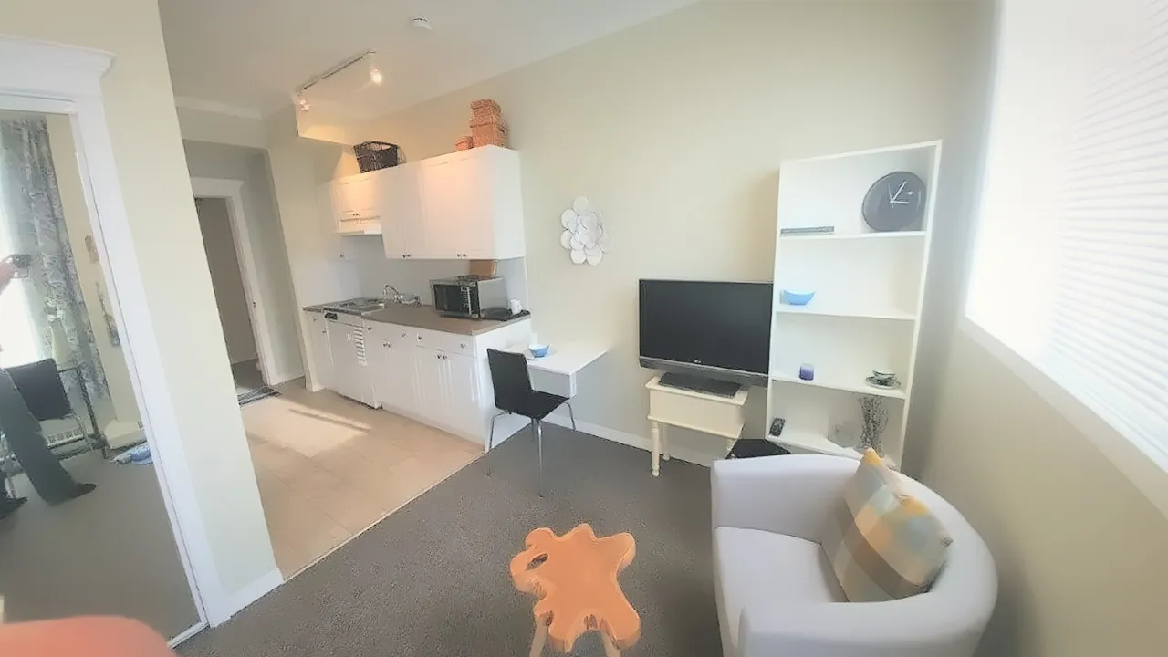 Self-contained suite with kitchenette, desk, TV and an armchair